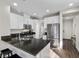Well-lit kitchen featuring granite countertops, stainless steel appliances, and white cabinetry at 8353 Lower Trailhead Ave, Las Vegas, NV 89113