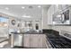 Modern kitchen with white cabinets, granite counters, stainless appliances, and open to a bright living area at 8353 Lower Trailhead Ave, Las Vegas, NV 89113
