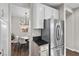 Bright kitchen featuring white cabinets, stainless steel appliances, granite counters, and modern dining nook at 8353 Lower Trailhead Ave, Las Vegas, NV 89113