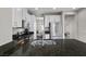 Open kitchen with dark granite, stainless steel appliances, and a central island for cooking and entertaining at 8353 Lower Trailhead Ave, Las Vegas, NV 89113