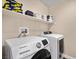 Modern laundry room equipped with a Samsung washer and dryer and shelving for storage at 8353 Lower Trailhead Ave, Las Vegas, NV 89113