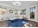 Bright and spacious living room with stylish decor, a large sectional sofa, and access to the backyard at 8353 Lower Trailhead Ave, Las Vegas, NV 89113