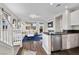 Bright living room featuring stainless steel appliances, dark countertops, and a comfortable seating area at 8353 Lower Trailhead Ave, Las Vegas, NV 89113
