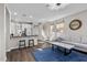 Open-concept living space featuring a bar counter, a staircase, and a comfortable living room area at 8353 Lower Trailhead Ave, Las Vegas, NV 89113