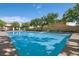 Beautiful community pool with tanning deck and plenty of lounge seating for residents to relax and enjoy the sun at 8353 Lower Trailhead Ave, Las Vegas, NV 89113