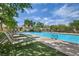 Inviting community pool with lounge chairs and well-maintained turf, perfect for relaxation and enjoying sunny days at 8353 Lower Trailhead Ave, Las Vegas, NV 89113