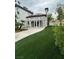 Lush backyard featuring manicured turf and a covered patio, ideal for relaxation and outdoor enjoyment at 8761 Rainbow Ridge Dr, Las Vegas, NV 89117