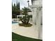 Lush backyard with pool, patio, pergola, and mature trees at 8761 Rainbow Ridge Dr, Las Vegas, NV 89117
