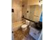Well-lit bathroom featuring a tub, toilet, and decorative bowl sink on a dark marble countertop at 8761 Rainbow Ridge Dr, Las Vegas, NV 89117