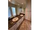 Bathroom vanity with granite countertops, double sinks, and stylish tile flooring, providing a luxurious feel at 8761 Rainbow Ridge Dr, Las Vegas, NV 89117