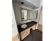 Stylish bathroom with a vessel sink, dark countertops, and custom cabinetry, blending functionality and design at 8761 Rainbow Ridge Dr, Las Vegas, NV 89117