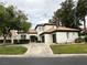 Charming single-story home featuring a lush front lawn, tile roof and three-car garage at 8761 Rainbow Ridge Dr, Las Vegas, NV 89117