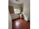 Bright laundry room with wood cabinets, sink, and wood-look floors at 8761 Rainbow Ridge Dr, Las Vegas, NV 89117