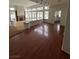 Bright living room features dark wood flooring, a fireplace, and many windows for lots of natural light at 8761 Rainbow Ridge Dr, Las Vegas, NV 89117