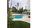 A backyard pool, spa, patio, landscaping, and artificial grass at 8761 Rainbow Ridge Dr, Las Vegas, NV 89117