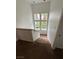 Well-lit staircase with carpet and window views, providing an inviting transition between levels at 8761 Rainbow Ridge Dr, Las Vegas, NV 89117