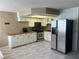 Open kitchen featuring white cabinetry, stainless steel appliances, and tile flooring at 901 Sulphur Springs Ln # 101, Las Vegas, NV 89128