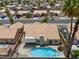Aerial view of backyard with a sparkling blue swimming pool, spa, and mature palm trees at 920 Serpentina Ave, Las Vegas, NV 89123