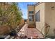 Private backyard with brick patio, bordered by stucco house and block wall, with gated access at 920 Serpentina Ave, Las Vegas, NV 89123