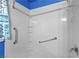 Accessible bathroom with safety grab bars, shower head and handy corner shelf at 920 Serpentina Ave, Las Vegas, NV 89123