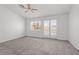 Bedroom featuring a ceiling fan, carpet, and access to patio at 920 Serpentina Ave, Las Vegas, NV 89123