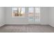 Bedroom with carpet, natural light, and sliding glass door to the backyard at 920 Serpentina Ave, Las Vegas, NV 89123