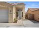 Home exterior featuring desert landscaping and a convenient attached garage at 920 Serpentina Ave, Las Vegas, NV 89123