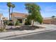 Attractive home featuring desert-friendly landscaping, mature trees, and an attached garage at 920 Serpentina Ave, Las Vegas, NV 89123