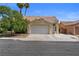 Charming single-story home with a two-car garage, desert landscaping, and a tile roof at 920 Serpentina Ave, Las Vegas, NV 89123