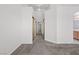 Hallway features plush carpeting and leads to bedrooms, bathrooms, and other living spaces at 920 Serpentina Ave, Las Vegas, NV 89123
