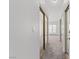 Hallway with mirror closet doors leading to a room with natural light at 920 Serpentina Ave, Las Vegas, NV 89123