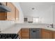 Kitchen with tile countertops and stainless steel dishwasher overlooking living space at 920 Serpentina Ave, Las Vegas, NV 89123