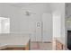 Bright kitchen featuring white cabinets, tile floors, and modern ceiling fan at 920 Serpentina Ave, Las Vegas, NV 89123
