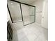 Modern bathroom with a glass enclosed shower and tiled floor at 9348 Wildcat Peak St, Las Vegas, NV 89178