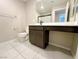 Bathroom featuring modern dark wood cabinets, sink, toilet, and a glass shower at 9348 Wildcat Peak St, Las Vegas, NV 89178