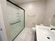 Clean bathroom with shower with glass door, sink, toilet, and dark wood cabinets at 9348 Wildcat Peak St, Las Vegas, NV 89178