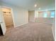 Cozy upstairs loft area with carpeting, offering versatile living space, and access to a closet and other rooms at 9348 Wildcat Peak St, Las Vegas, NV 89178