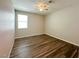 Bright bedroom with hardwood floors, a ceiling fan, and a window at 9348 Wildcat Peak St, Las Vegas, NV 89178
