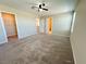 Large bedroom with carpet, ceiling fan, access to a walk-in closet, and a window, creating an inviting and functional space at 9348 Wildcat Peak St, Las Vegas, NV 89178