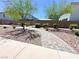 Community park featuring a stone pathway, decorative rocks, young trees, and various plants at 9348 Wildcat Peak St, Las Vegas, NV 89178
