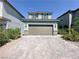 Two-story home features a wide driveway, two-car garage, and simple landscaping for great curb appeal at 9348 Wildcat Peak St, Las Vegas, NV 89178