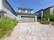 Two-story home features a wide driveway, two-car garage, and simple landscaping for great curb appeal at 9348 Wildcat Peak St, Las Vegas, NV 89178