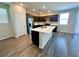 Modern kitchen features a large island, stainless steel appliances, and dark cabinets at 9348 Wildcat Peak St, Las Vegas, NV 89178