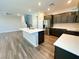 Well-lit kitchen with a central island, stainless steel appliances, and ample cabinet space at 9348 Wildcat Peak St, Las Vegas, NV 89178