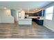 Open-concept kitchen features stainless steel appliances, a large island, and dark cabinetry at 9348 Wildcat Peak St, Las Vegas, NV 89178