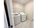 Convenient laundry room featuring modern appliances and upper shelving for storage at 9348 Wildcat Peak St, Las Vegas, NV 89178