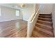 View of the staircase leading upstairs with wood flooring transitioning to carpeted stairs, offering a stylish and comfortable transition at 9348 Wildcat Peak St, Las Vegas, NV 89178