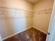 Walk-in closet with wall-mounted metal shelving and neutral carpeting at 9348 Wildcat Peak St, Las Vegas, NV 89178