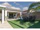 Backyard featuring artificial grass, outdoor dining, and an outdoor workout area by the house at , North Las Vegas, NV 89031