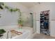 Clean bathroom with a garden tub, glass-enclosed shower, and an organized walk-in closet at , North Las Vegas, NV 89031